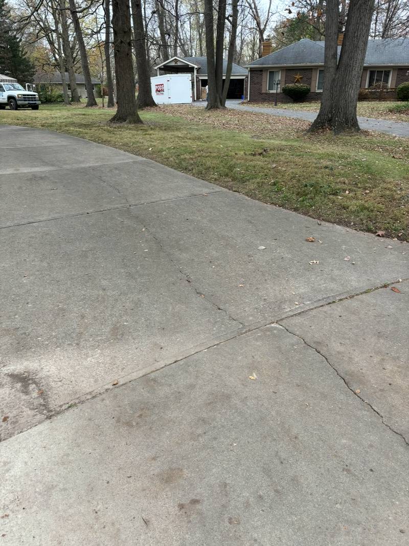 The same driveway and side lawn after clearing