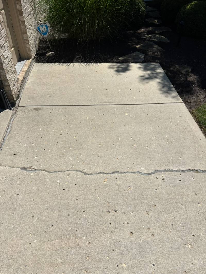 The same concrete walk clean after pressure washing