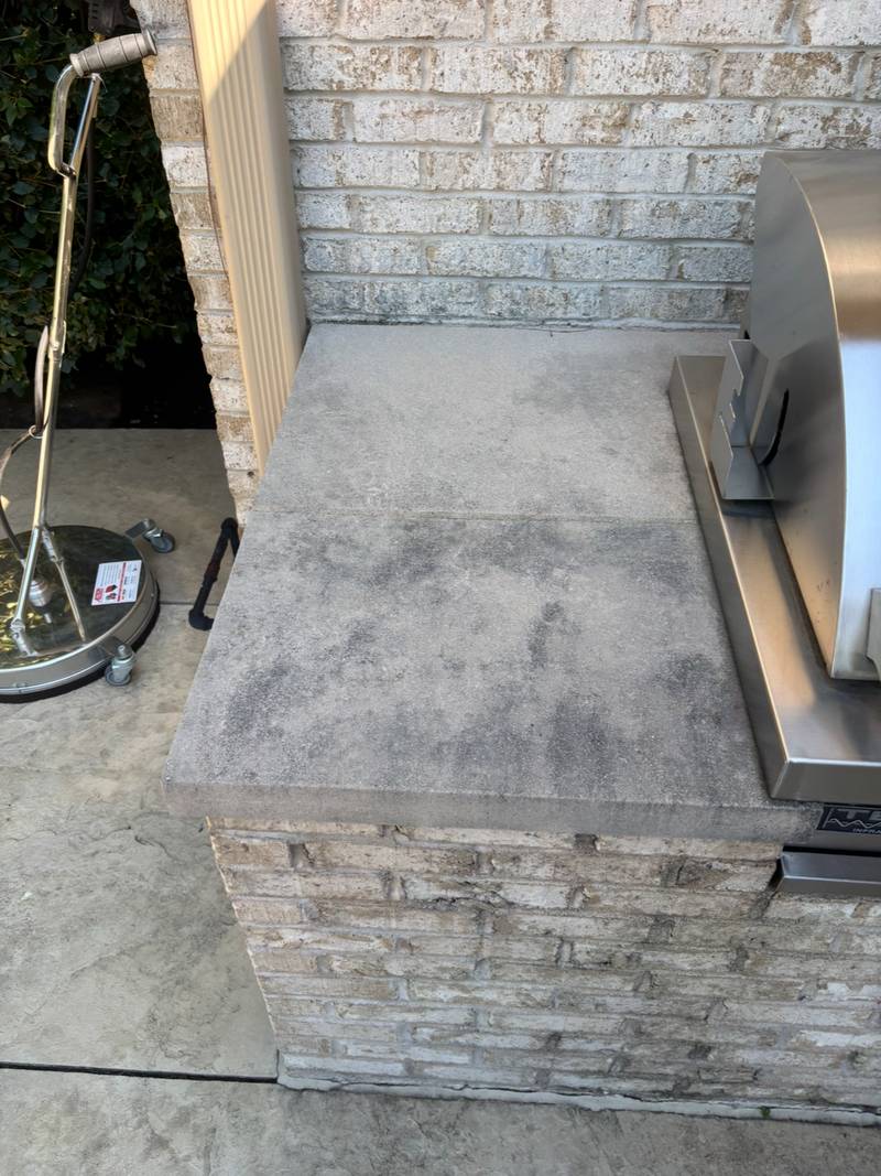 Outdoor concrete counter stained before cleaning