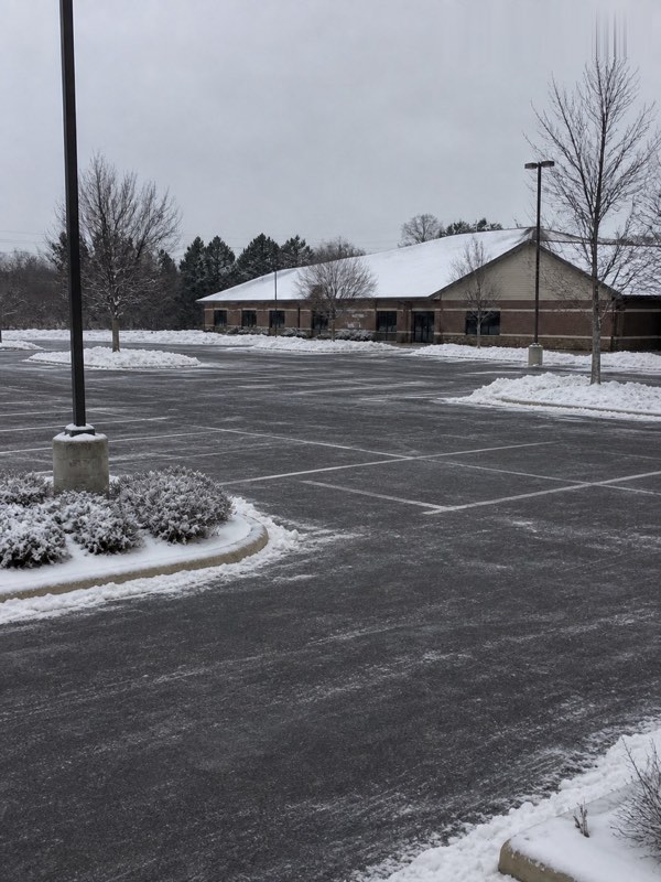 Illustration — the same commercial parking lot after plowing